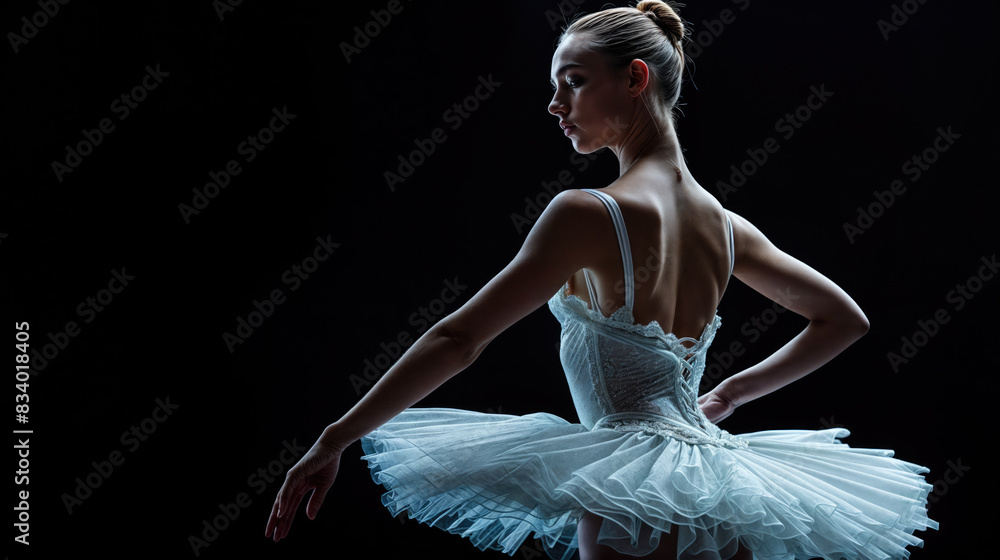 Fototapeta premium ballerina in white tutu on dark stage