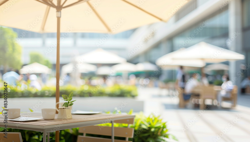 Fototapeta premium a of a hospital's outdoor cafeteria seating area with tables and umbrellas, featuring a blurred background of patients and staff enjoying meals, Exterior, hospital,