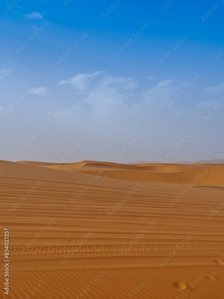 Beautiful panoramic view of sand dunes with car tracks in the Sahara desert, Merzouga, Morocco, North Africa Beautiful panoramic view of sand dunes with car tracks in the Sahara desert, Merzouga, Morocco, North Africa
