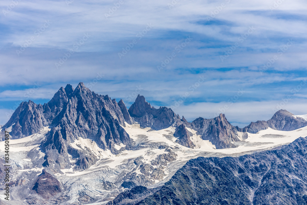 Naklejka premium Chamonix Montblanc beautiful alpine mountain summits landscape. Alps mountains with snow and glacier above green valley of Chamonix in France. Alps beautiful scenery in summer