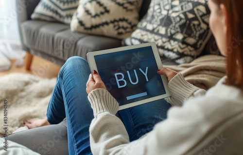 Person Sitting on Couch Holding Tablet