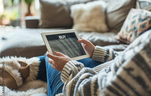 Person Sitting on Couch Holding Tablet
