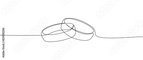 One continuous line drawing of wedding rings. Romantic elegance concept and symbol of proposal, engagement, and love marriage in simple linear style.
