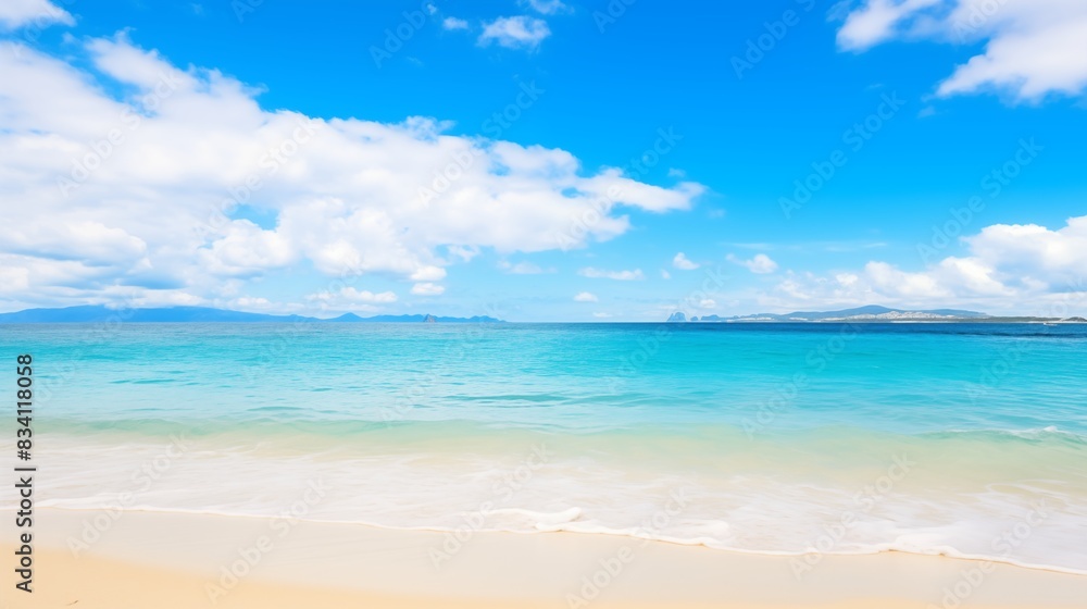 A Beautiful Beach Scene with Tranquil Turquoise Waters and White Sand Under a Blue Sky A Beautiful Beach Scene with Tranquil Turquoise Waters and White Sand Under a Blue Sky