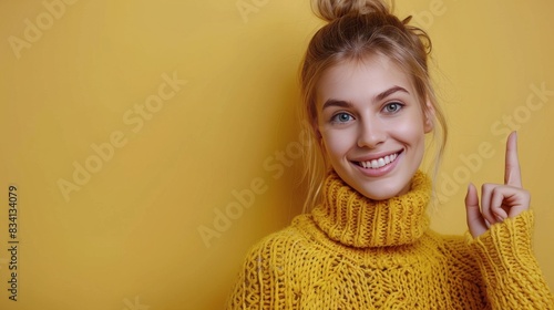 Young Woman Smiling In Yellow Sweater Against Yellow Wall