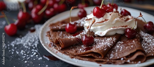 Chocolate crepes with cherries and whipped cream