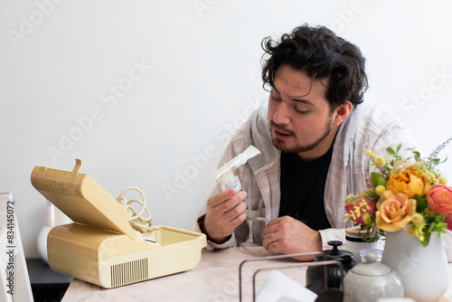 Person with respiratory problems in the living room trying to used a old nebulizer and get confused
