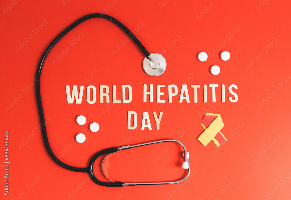 Stethoscope, pills tape and the inscription World Hepatitis Day on red. Stethoscope, pills tape and the inscription World Hepatitis Day on red.