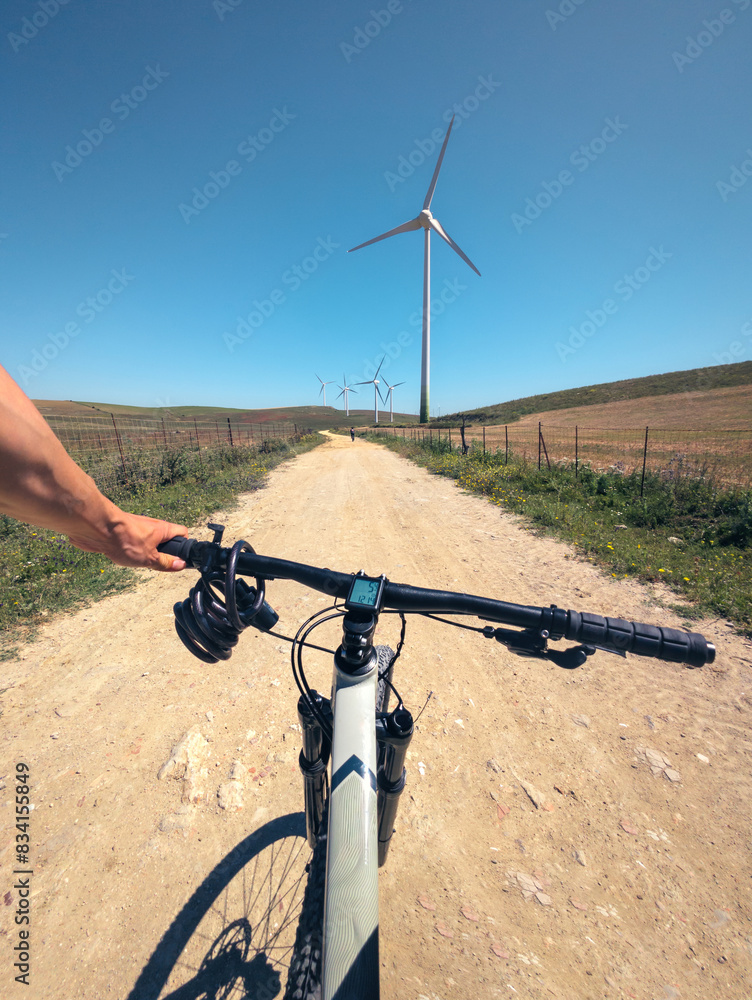 Biker's Perspective on a Dirt Road with Windmills Biker's Perspective on a Dirt Road with Windmills
