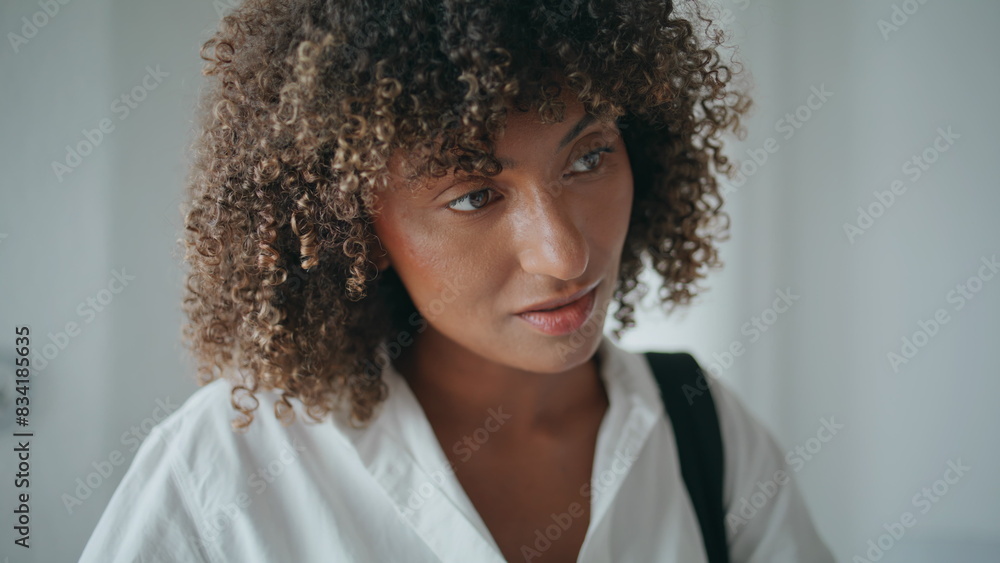 Smiling african american talking receptionist closeup. Curly woman writing form Smiling african american talking receptionist closeup. Curly woman writing form