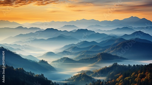 A misty mountain range with layers of fog and sunrise colors 