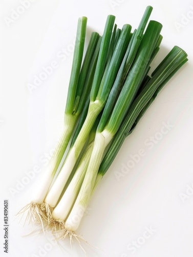 Close-up shot of fresh green onions arranged on a white surface  perfect for food or decoration images