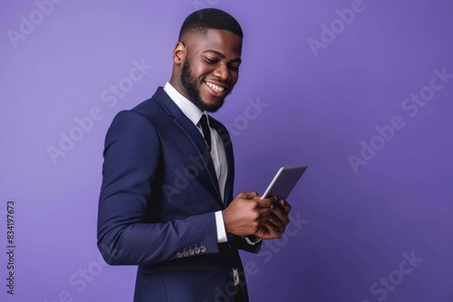 A man in a suit holds a tablet computer, great for business, finance or tech-related images