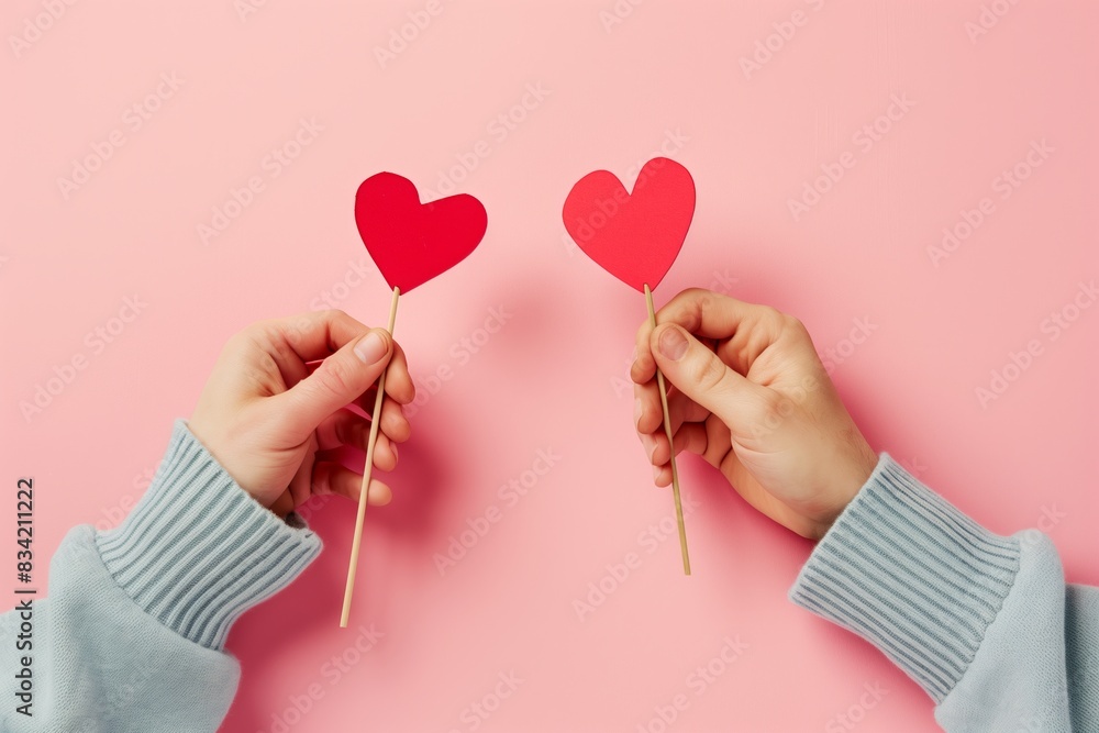 Young Adult Couple Holding Heart Shapes: Love Concept Closeup Young Adult Couple Holding Heart Shapes: Love Concept Closeup