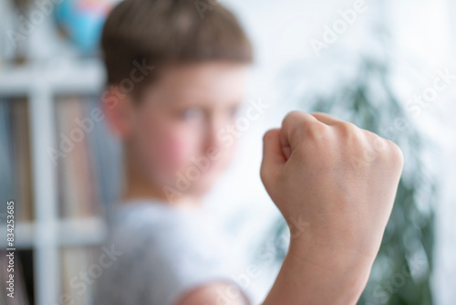 aggressive child with Attention deficit hyperactivity disorder threatening with fist, Social challenges, child psychology, aggressive behavior, hyperactive child, emotional outburst