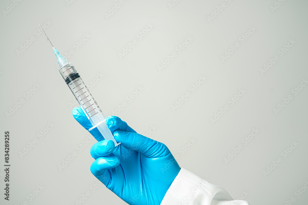 doctor or scientist holding a syringe in blue gloves doctor or scientist holding a syringe in blue gloves