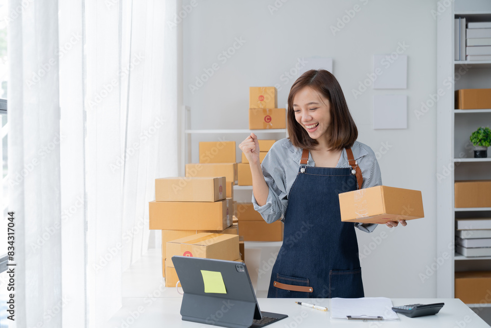 SME entrepreneur Small business entrepreneurs Online selling ideas, Happy Asian business owner work on computer and a box at home, delivery SME procurement package box deliver to customers, SME entrepreneur Small business entrepreneurs Online selling ideas, Happy Asian business owner work on computer and a box at home, delivery SME procurement package box deliver to customers,