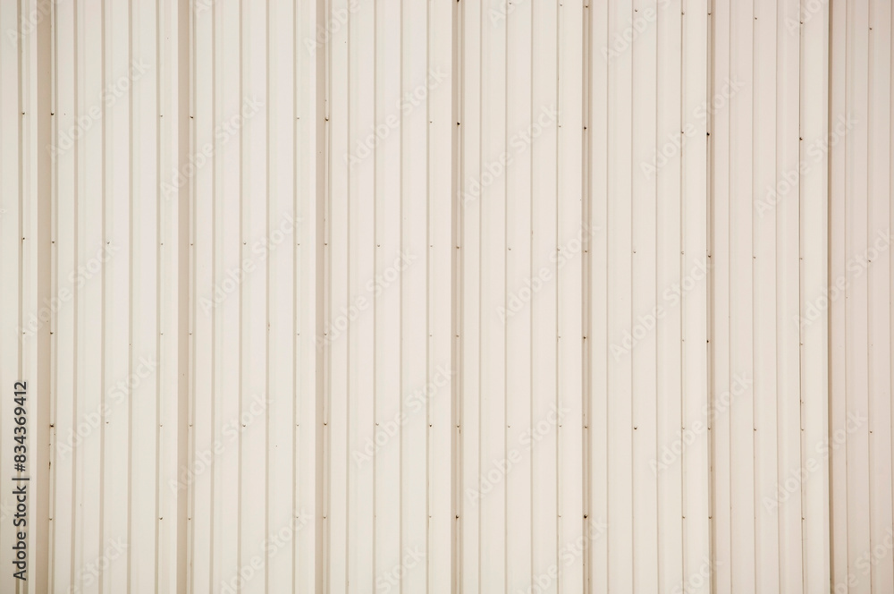 Vertical panels of beige tin cladding as a background texture Vertical panels of beige tin cladding as a background texture