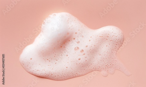 a soapy pink and white sponge with bubbles on a pink background