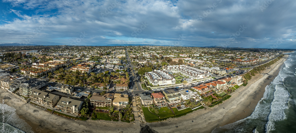 Obraz premium Aerial view of Carlsbad promenade, oceanside villas, holiday rentals with cloudy sky