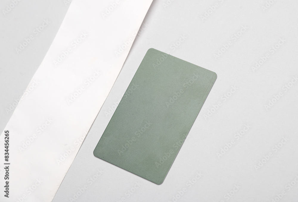 Fototapeta premium Receipt ribbon with credit card on a gray background. Mockup for design