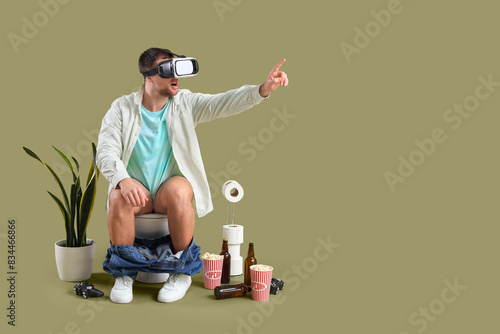 Young man using VR glasses ...