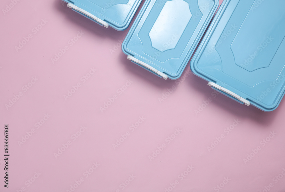 Blue Plastic containers for storing food on a pink background. Top view Blue Plastic containers for storing food on a pink background. Top view