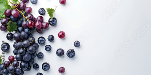 close-up view of a bunch of purple grapes falling from the top left corner onto a white background, The grapes are spherical with a green stem attached and are shown in various stages of falling.