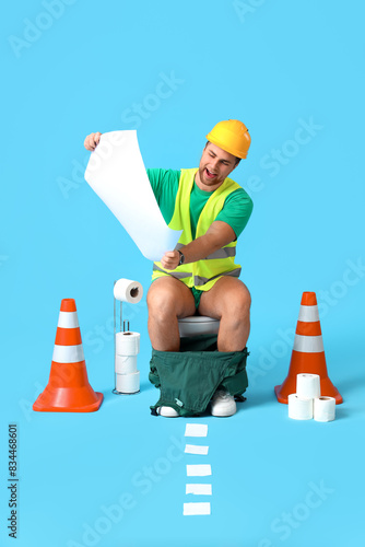 Male worker sitting on toil...