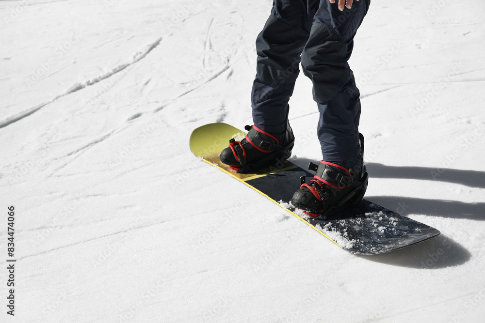 Fototapeta premium Male snowboarder on ski piste at snowy resort