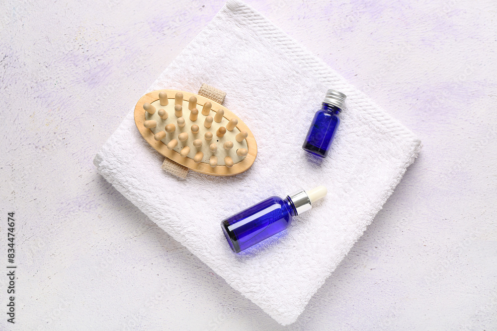 Bottles of serum, body massage brush and towel on white background Bottles of serum, body massage brush and towel on white background