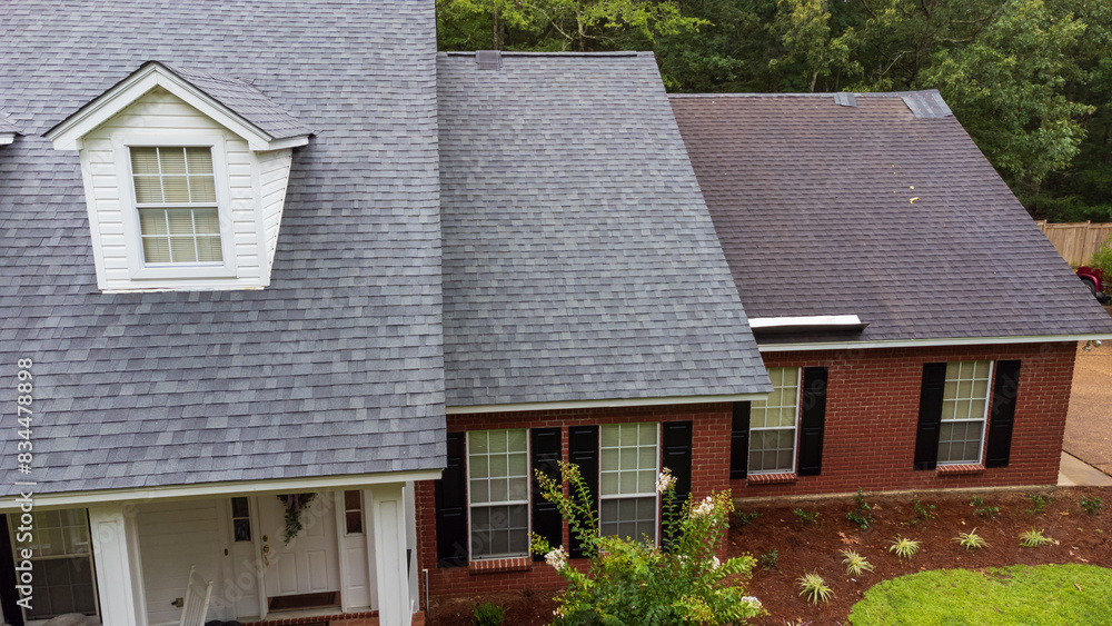 New roof and old roof on house, showing comparison of the two. New roof and old roof on house, showing comparison of the two.