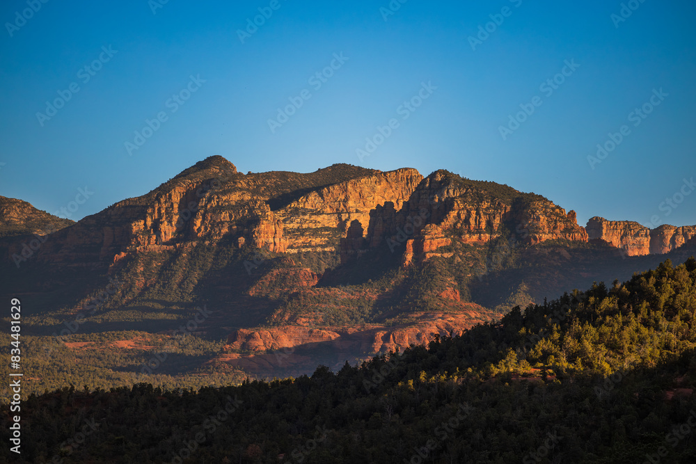 Desert mountain landscape at sunset with dramatic lighting and clear skies