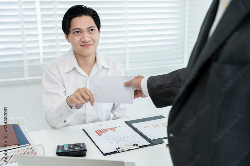 Businessmen receive salary or bonuses from management or Boss. Company give rewards to encourage work. Smiling businessman enjoying a reward at the desk in the office. Businessmen receive salary or bonuses from management or Boss. Company give rewards to encourage work. Smiling businessman enjoying a reward at the desk in the office.