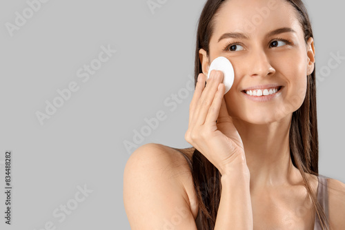 Young woman with cotton pad...