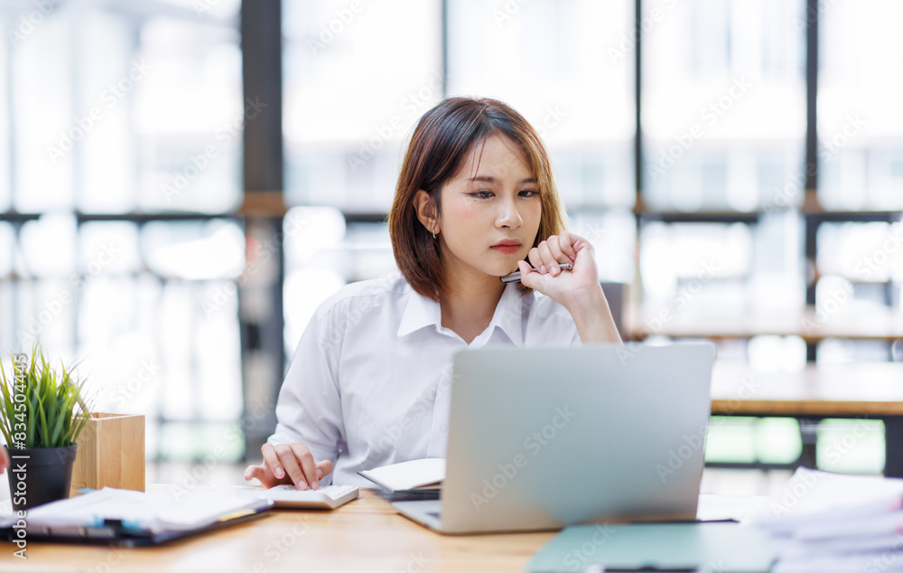 Portrait of happy asian female employee at computer Portrait of happy asian female employee at computer