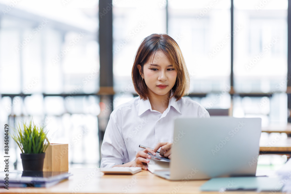 Portrait of happy asian female employee at computer Portrait of happy asian female employee at computer