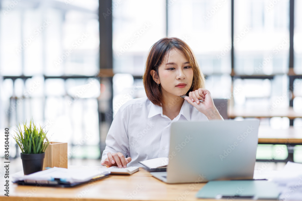 Portrait of happy asian female employee at computer Portrait of happy asian female employee at computer