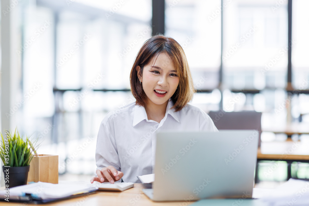 Portrait of happy asian female employee at computer Portrait of happy asian female employee at computer