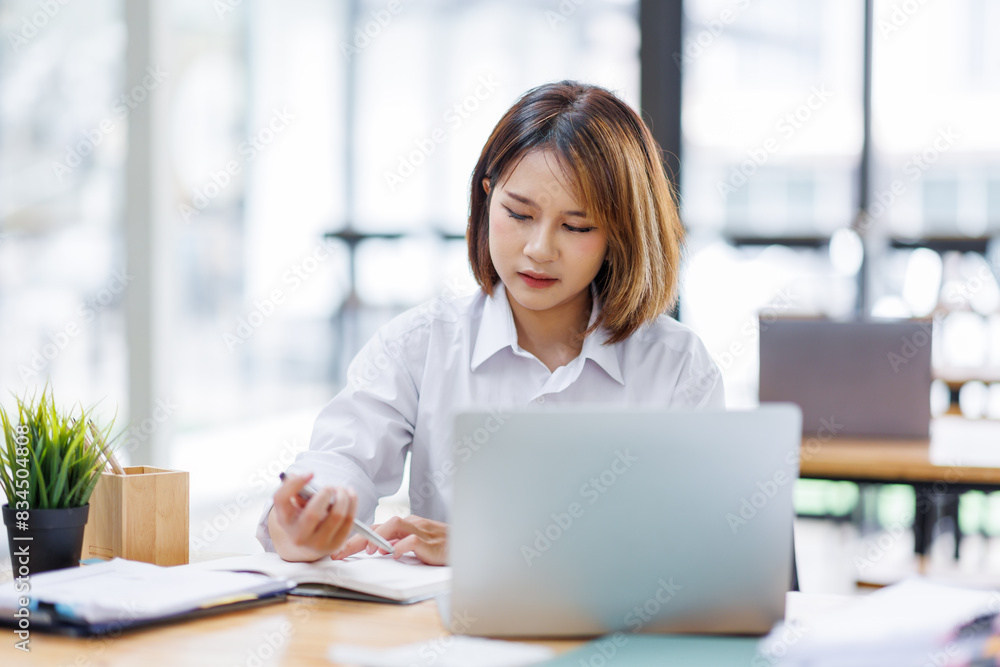 Portrait of happy asian female employee at computer Portrait of happy asian female employee at computer