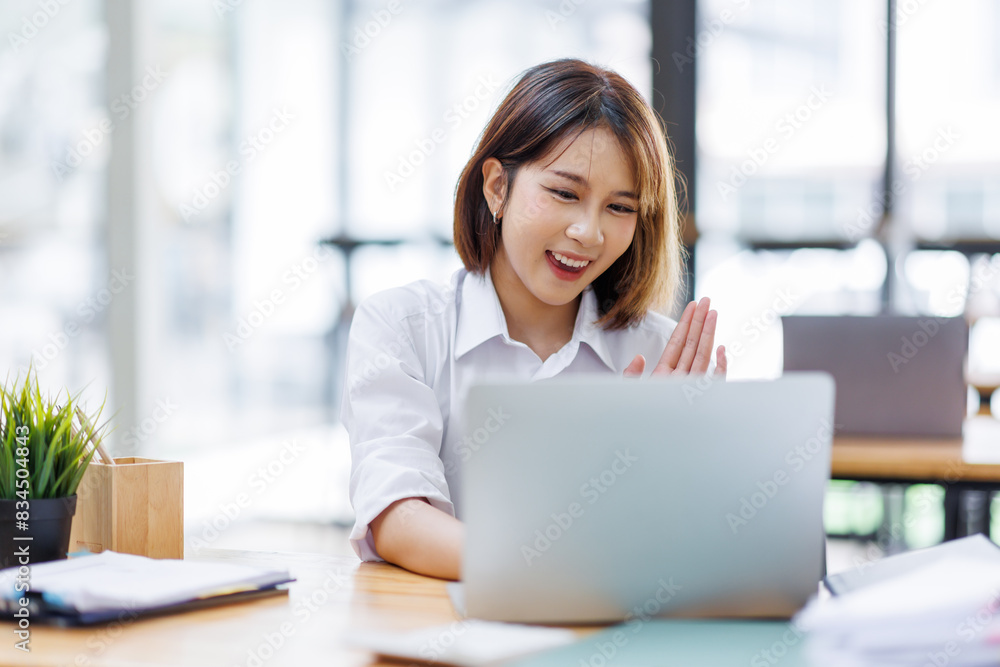 Portrait of happy asian female employee at computer Portrait of happy asian female employee at computer