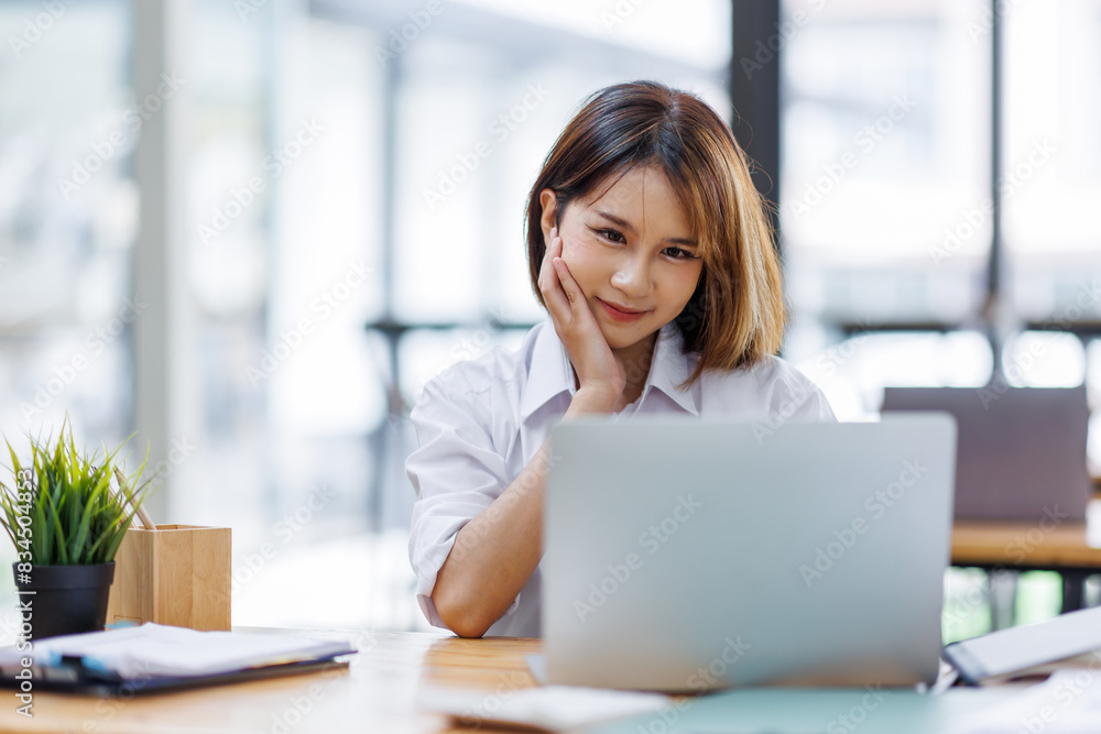 Portrait of happy asian female employee at computer Portrait of happy asian female employee at computer