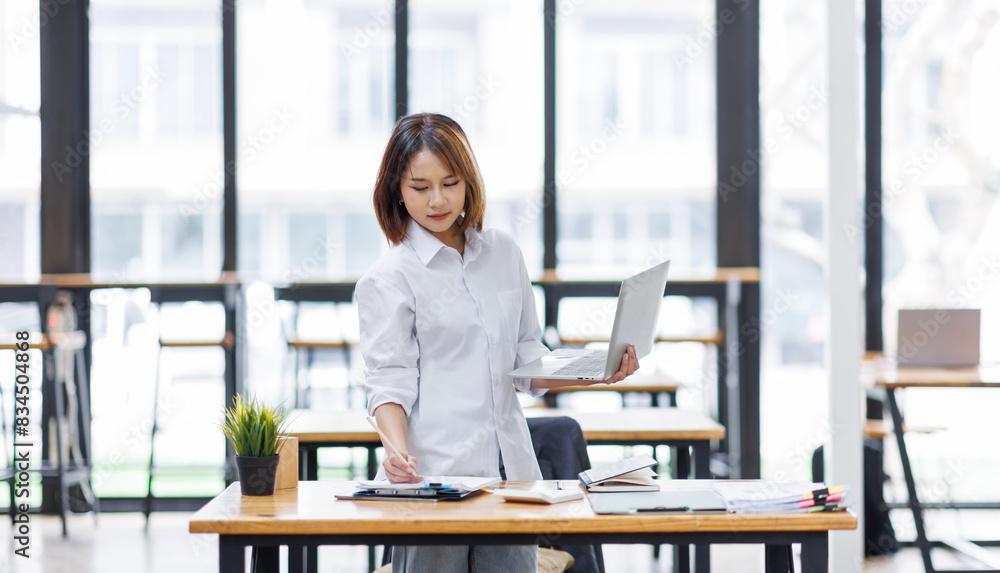 Portrait of happy asian female employee at computer Portrait of happy asian female employee at computer