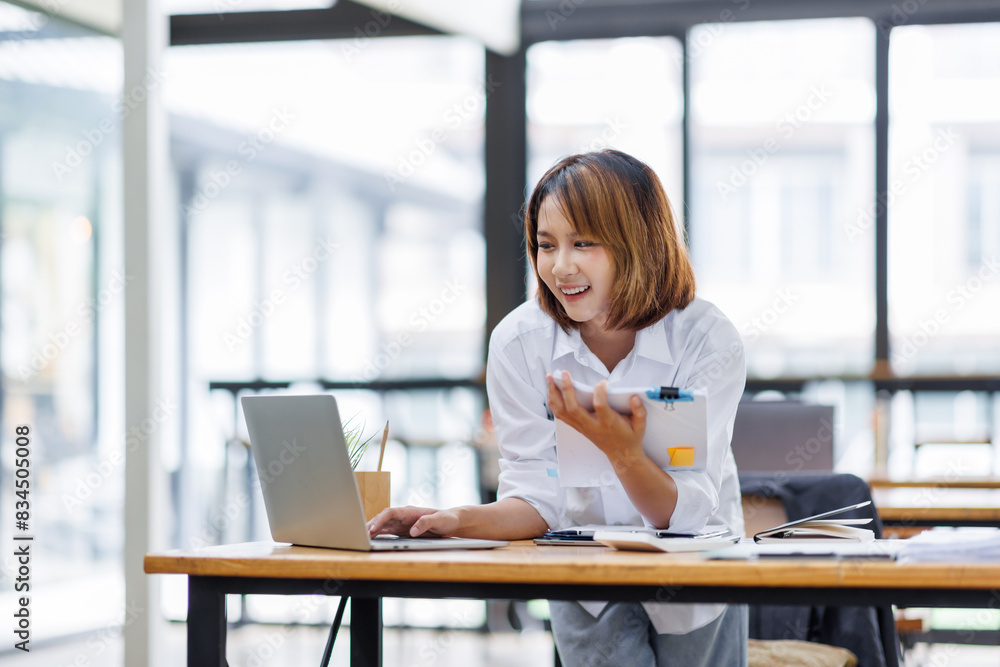 Portrait of happy asian female employee at computer Portrait of happy asian female employee at computer