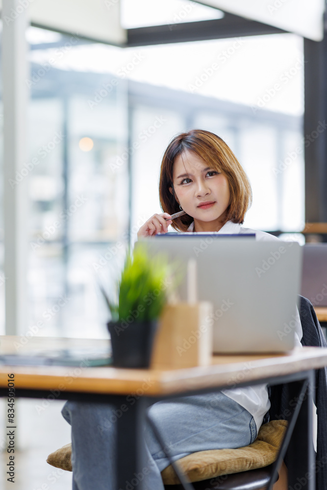 Portrait of happy asian female employee at computer Portrait of happy asian female employee at computer