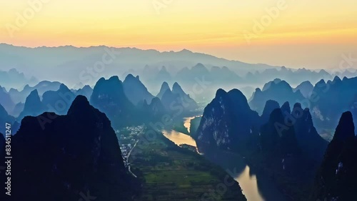Aerial view of karst mountain natural landscape at sunrise in Guilin, China. Panning shot. photo