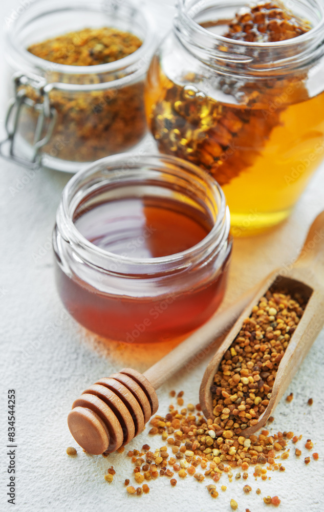 Raw organic bee pollen and honey in jars. Raw organic bee pollen and honey in jars.