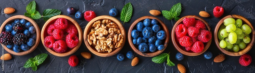 Assortment of fresh fruits in bowls: blueberries, raspberries, grapes and granola. Assortment of fresh fruits in bowls: blueberries, raspberries, grapes and granola.