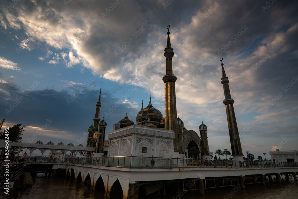 Naklejka premium people travel at Crystal Mosque or Masjid Kristal is a floating mosque in Kuala Terengganu, Terengganu, Malaysia. Dramratic sky