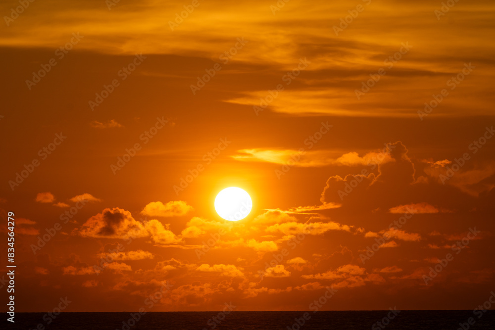 Fototapeta premium The sun behind the dark clouds, creating breathtaking ray of lights to its surrounding area during the sunset.
